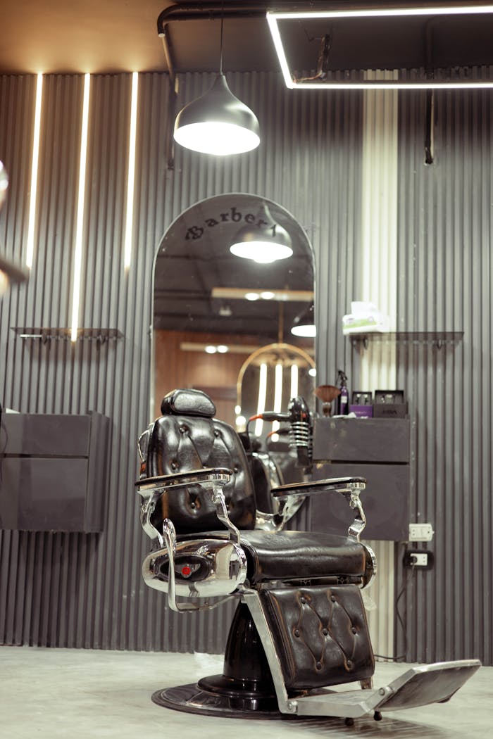 Vintage barber chair in a stylish, modern barbershop interior with soft lighting.